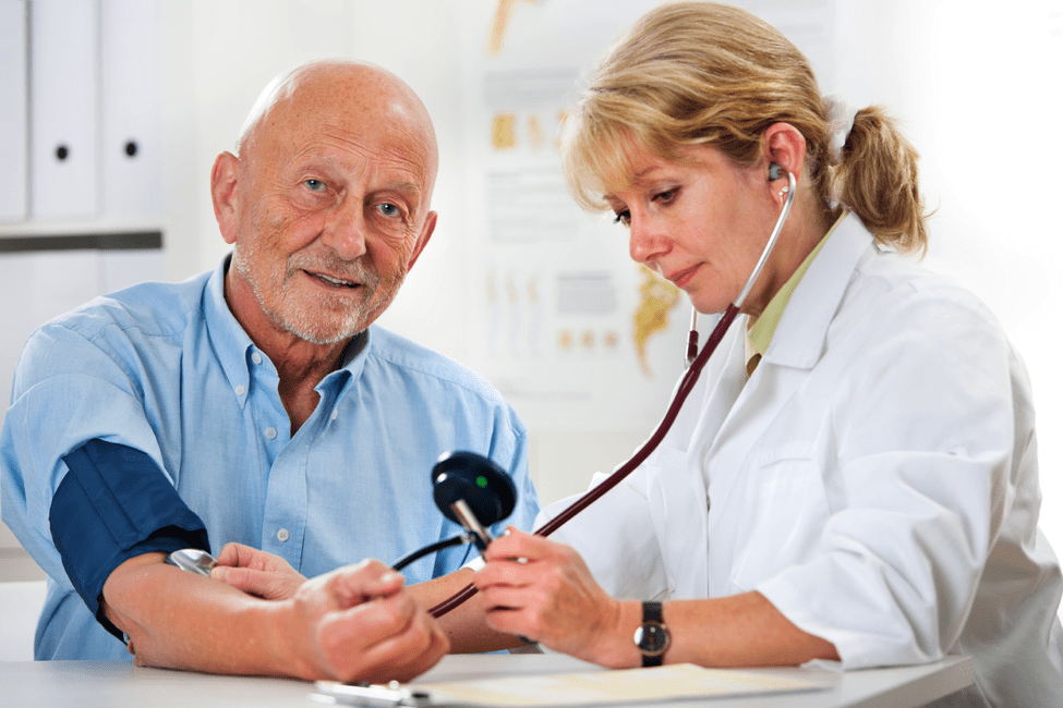 Man being checked for high blood pressure by doctor
