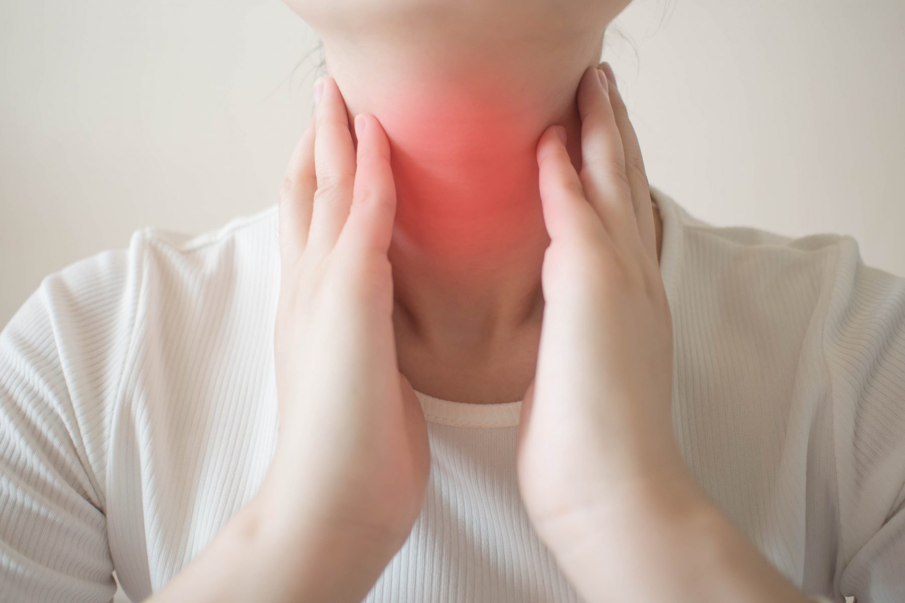 Female checking thyroid gland after swelling