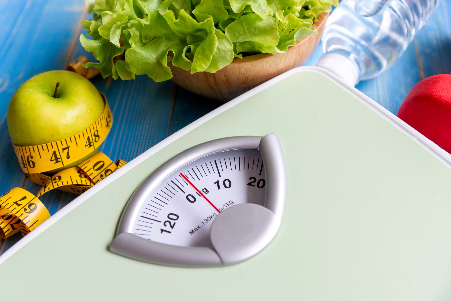 Scale and healthy food demonstrating weight loss
