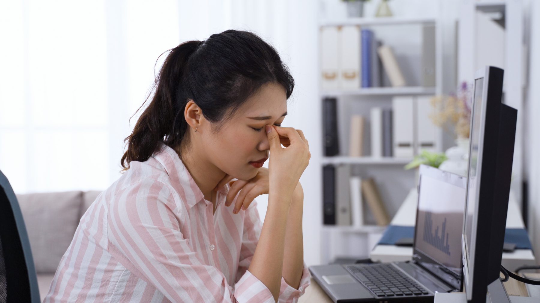 A lady with fatigue caused by staring at a computer screen.