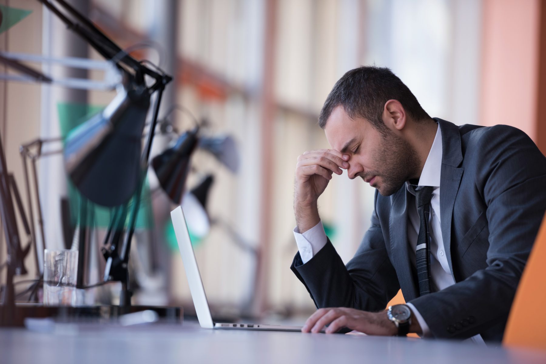 Business man at the office feeling bad representing oxidative stress