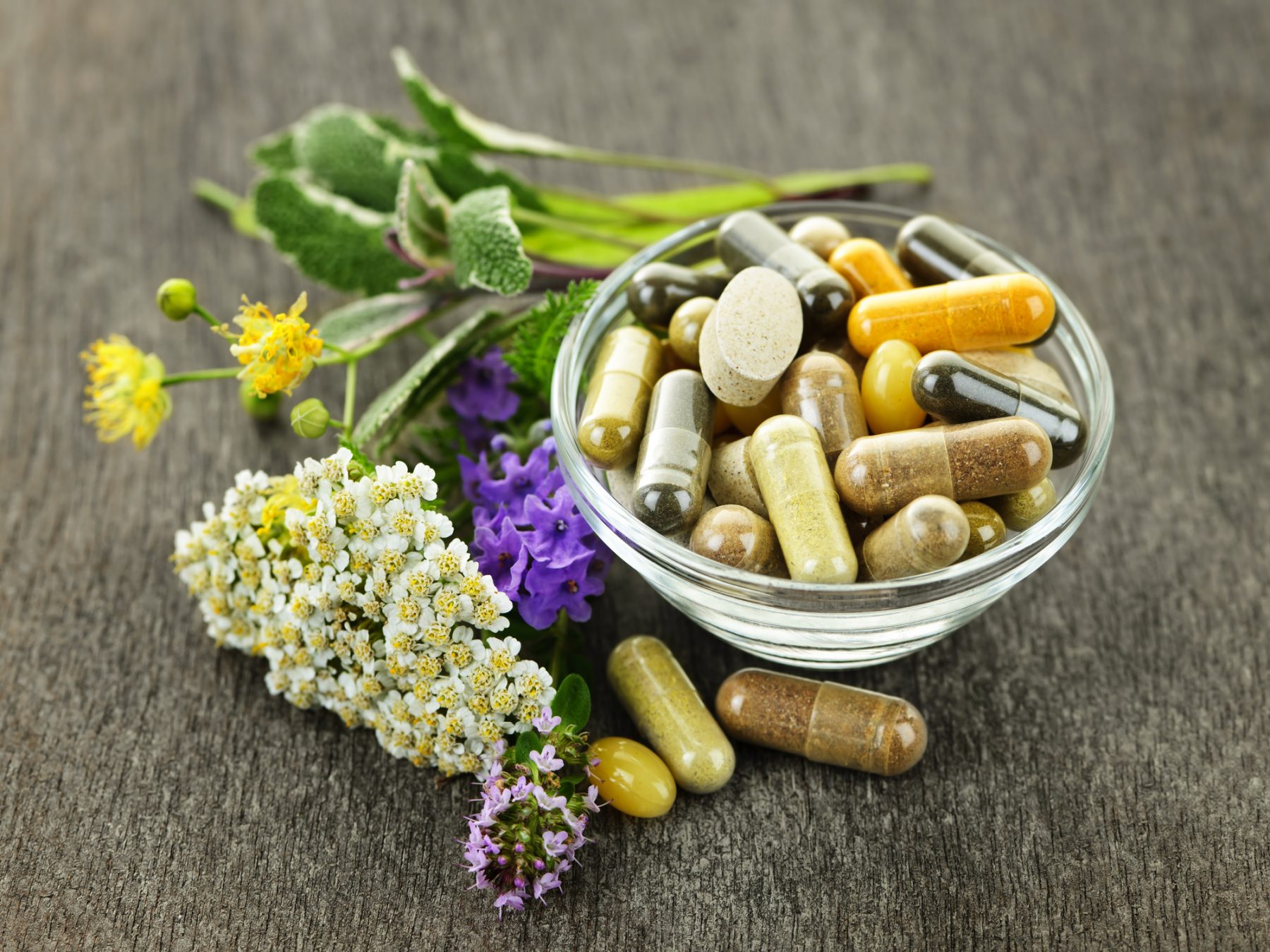 Herbal medicine, herbs, vitamins, and supplements in a bowl