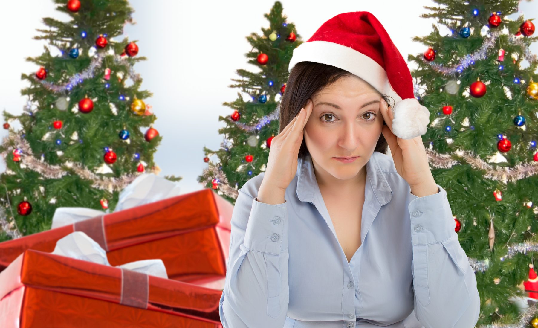 Woman with Christmas holiday stress in Santa cap with Christmas trees
