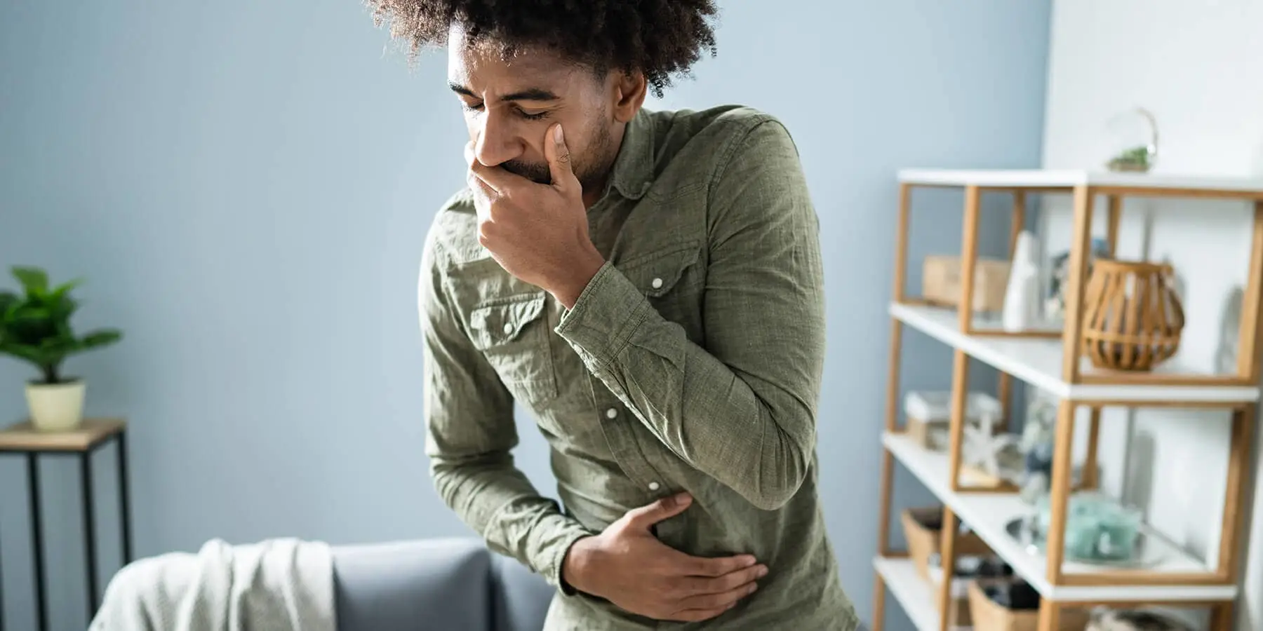 Man in his home with gut pain and nausea