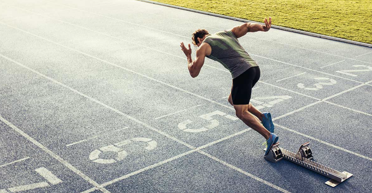 Athlete using starting block to sprint