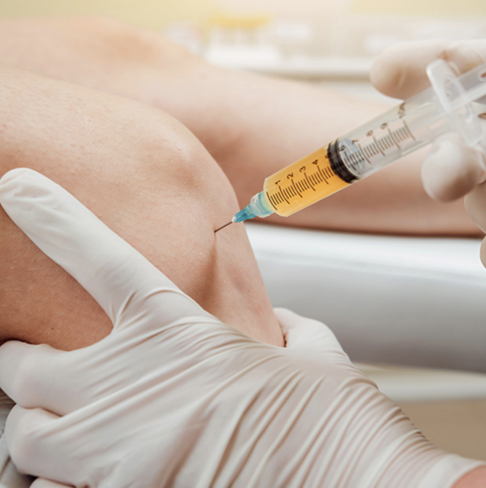 Woman receiving Prolozone therapy injection into the knee from a doctor