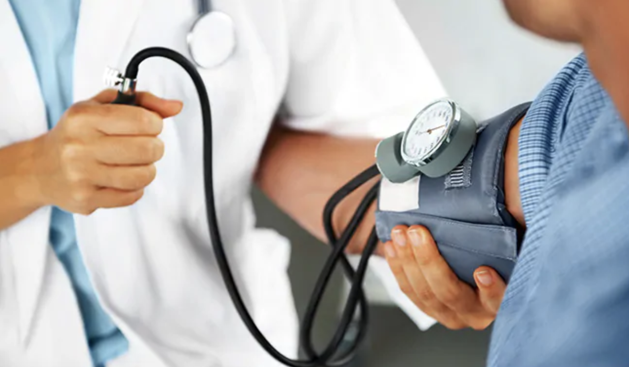 Doctor taking man's blood pressure