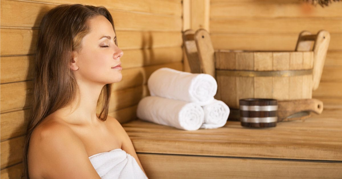 Woman detoxing and relaxing in a Sauna