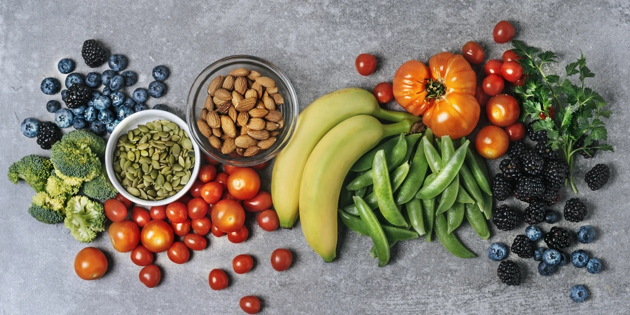 A collection of fruits, veggies, nuts, and seeds