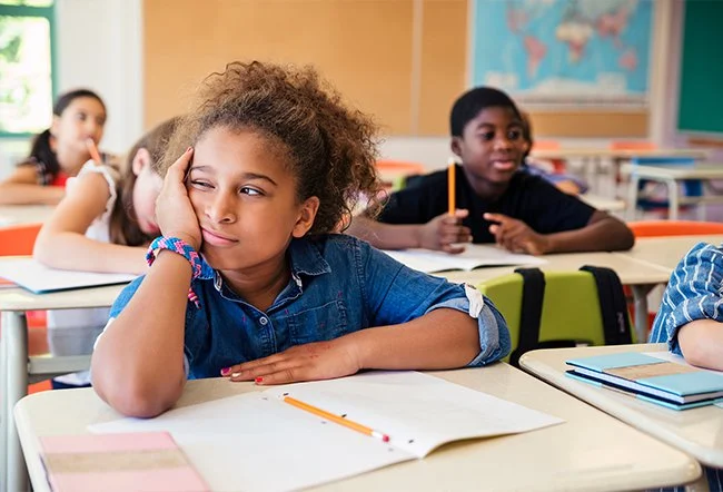 Bored child in school staring into space