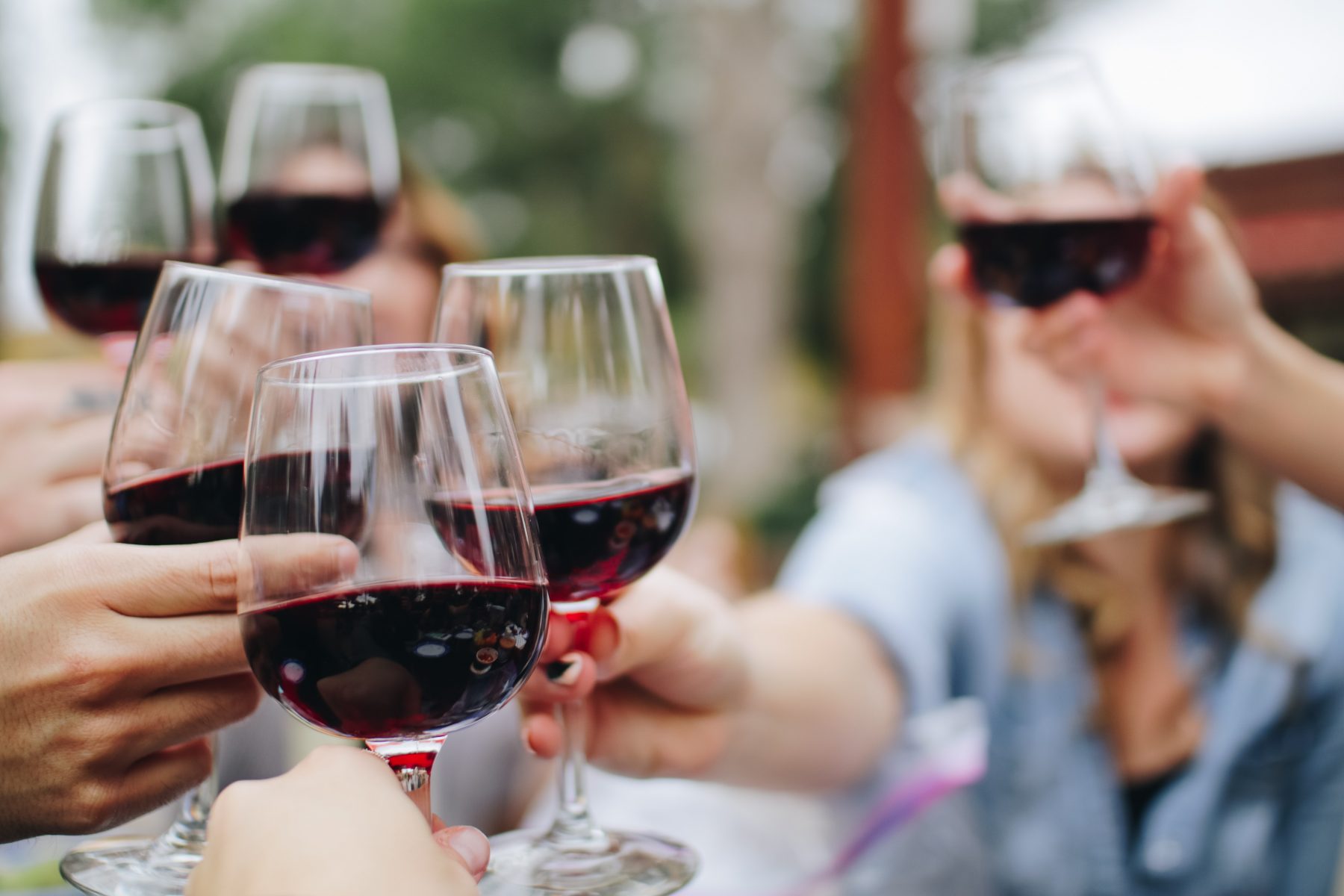 People toasting with glasses of red wine