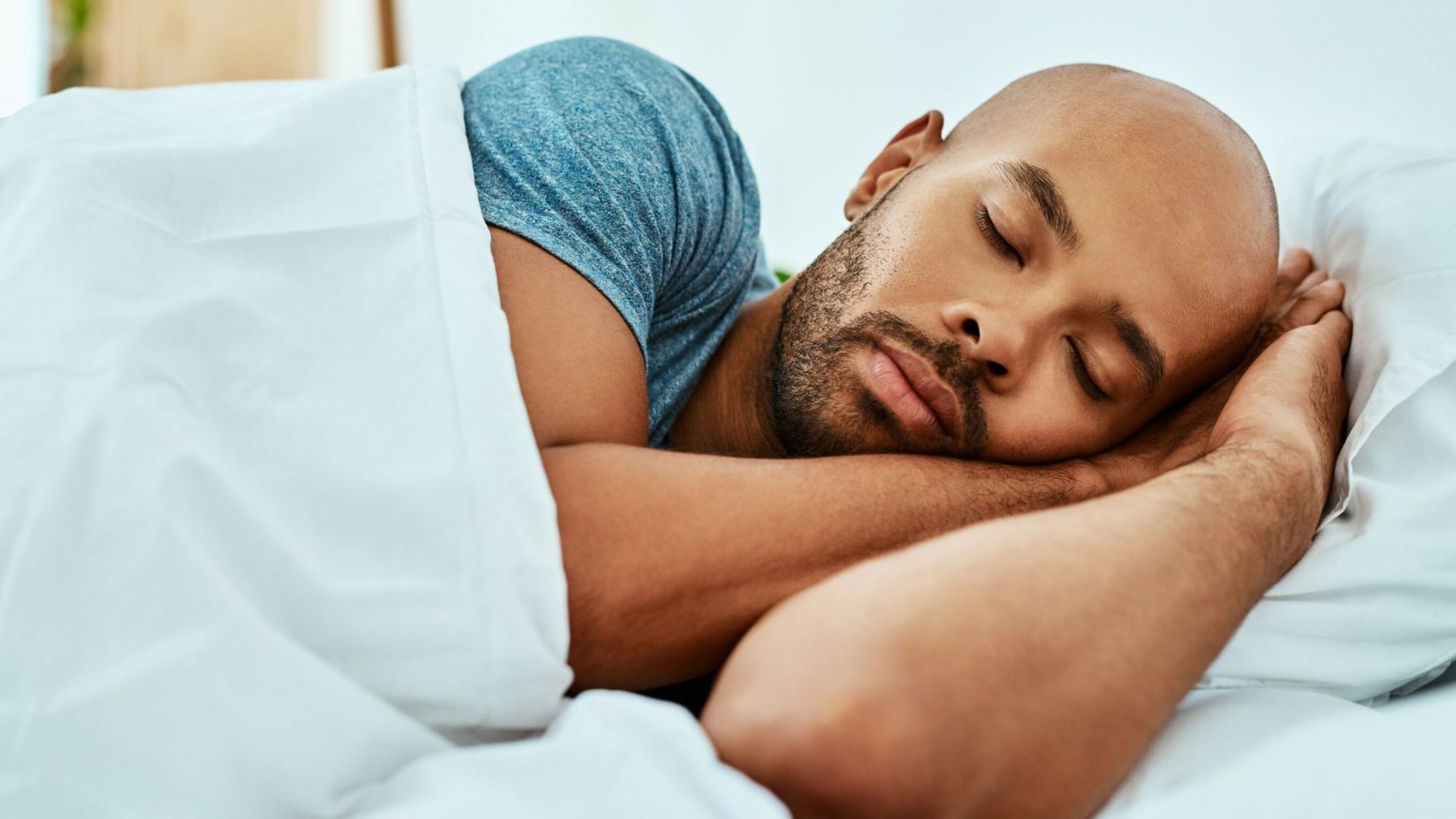 Man sleeping soundly in his bed
