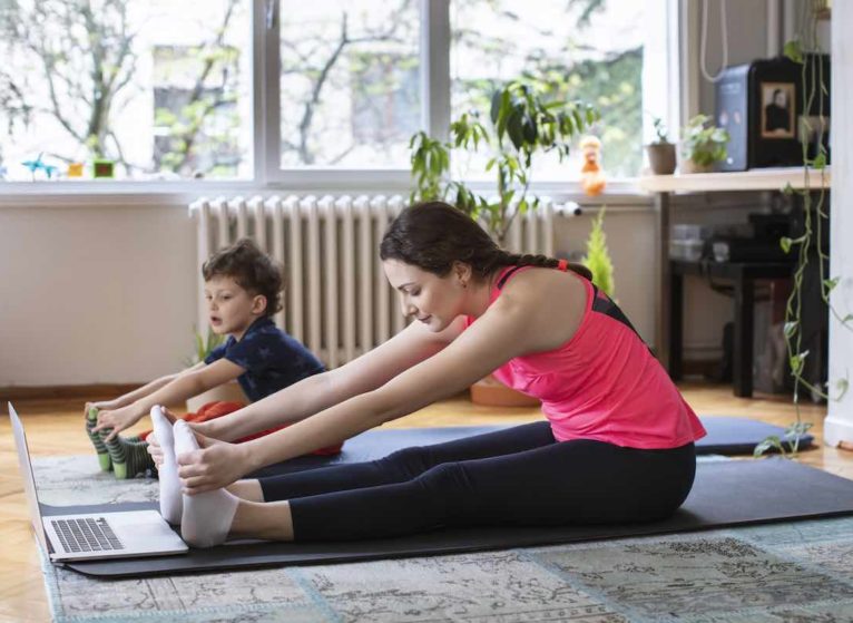 Mother and child doing stretching workouts