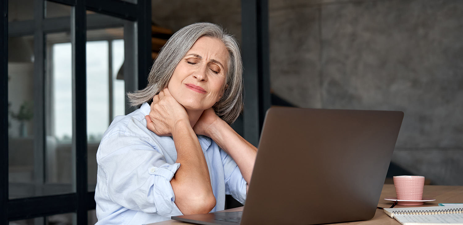Woman with chronic pain clutching her neck