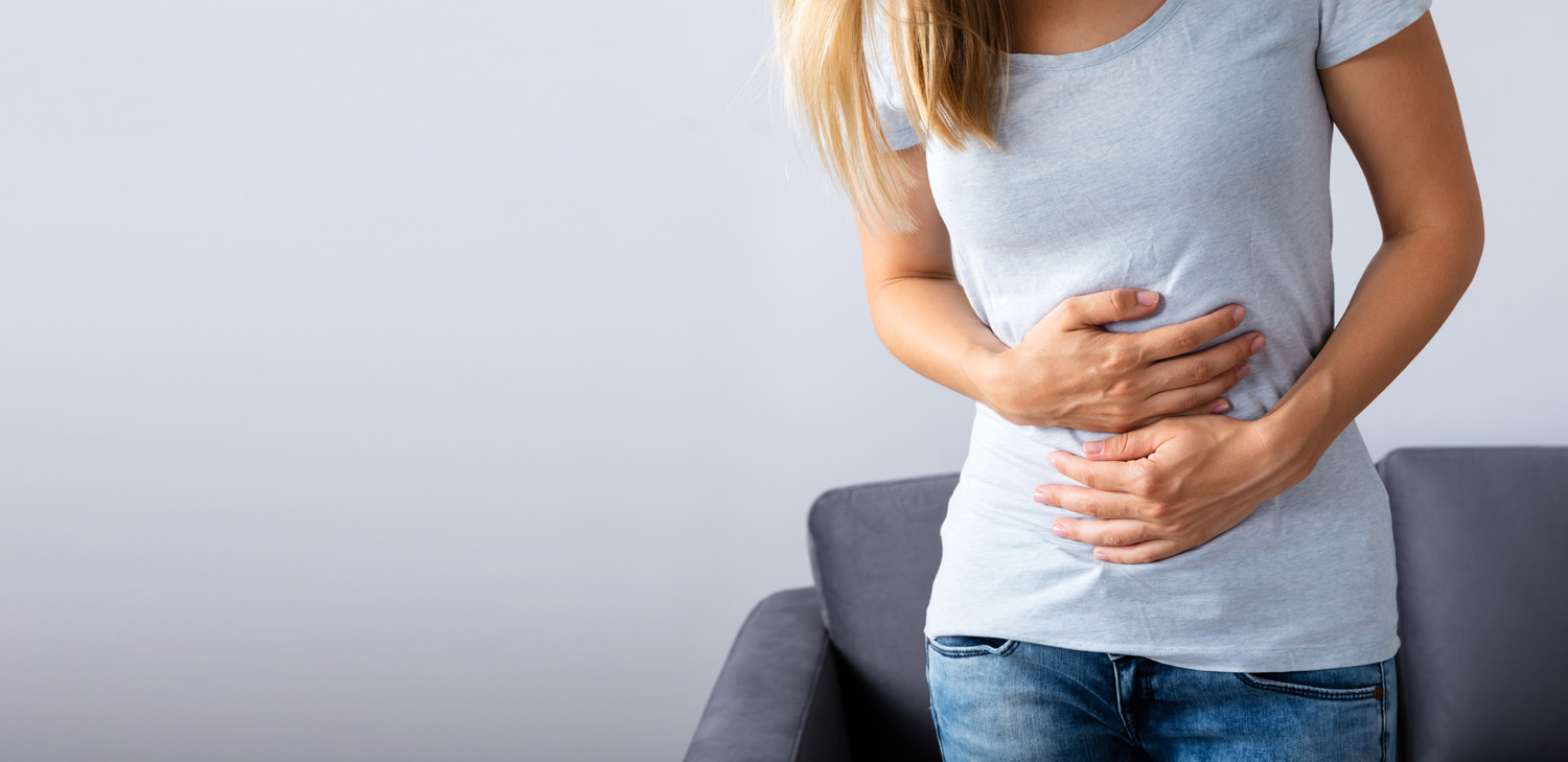 Woman with digestive disorders clutching her belly