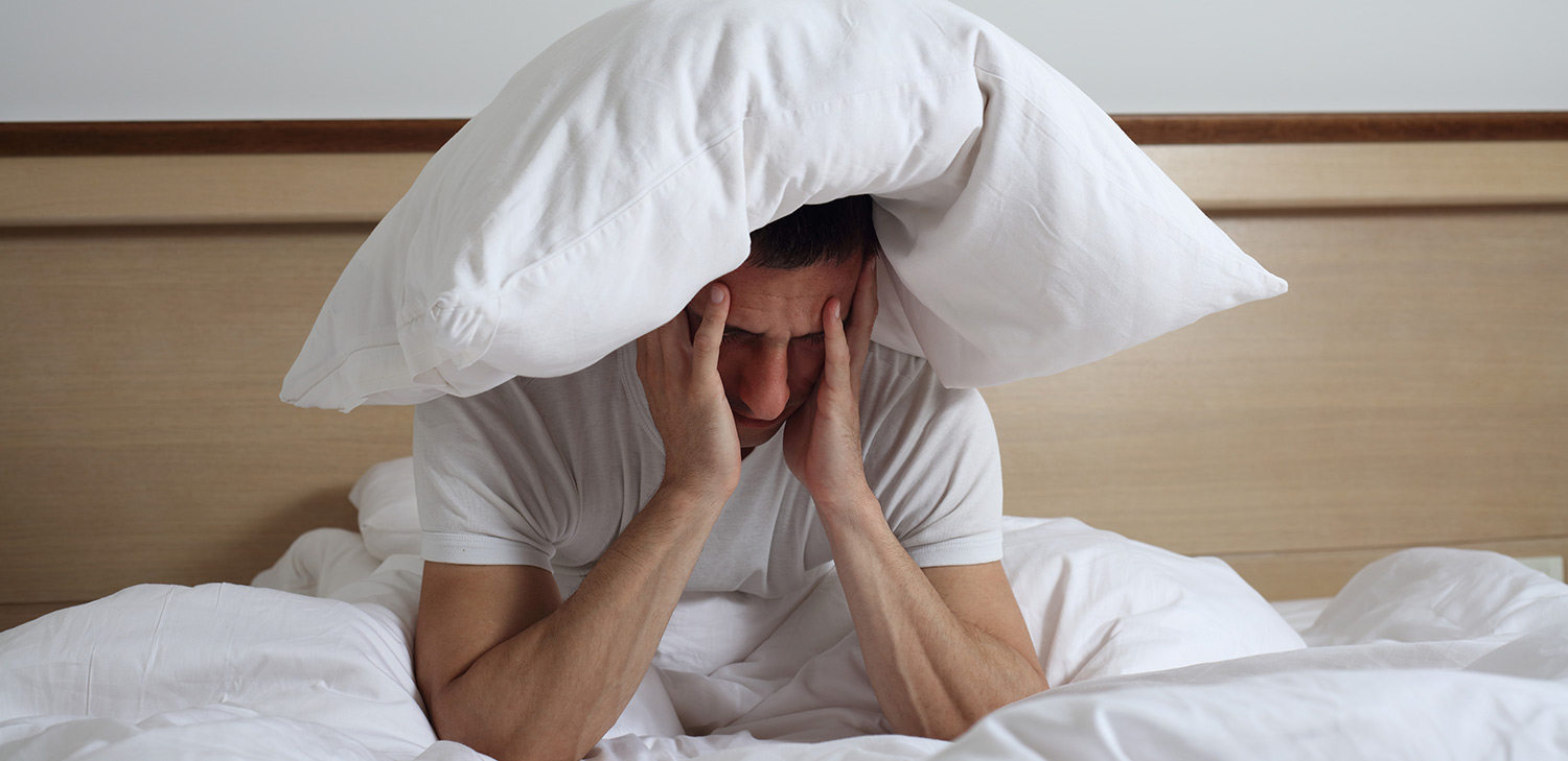 Man suffering from sleep disorders in bed