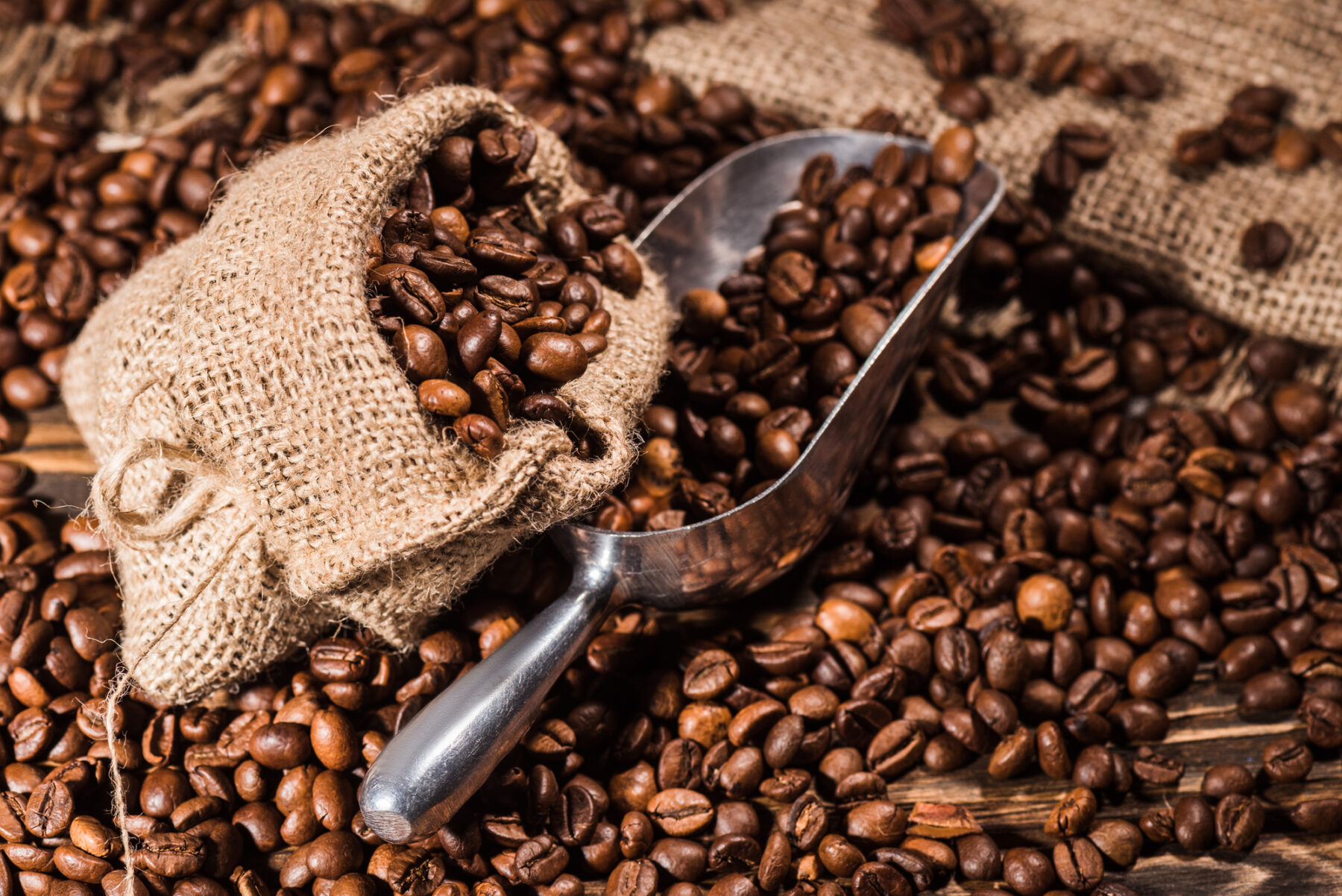 Coffee Beans spilling from a bag with scoop