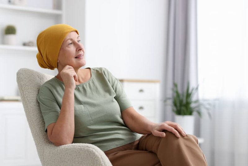 patient green shirt and yellow hat.